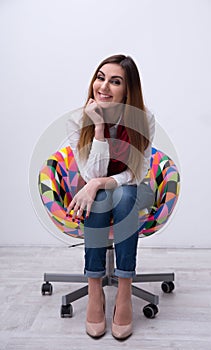 Woman sitting on the colourful chair