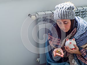 Woman sitting and counting euro banknotes near the battery