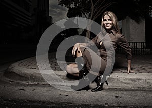 Woman sitting on the curb