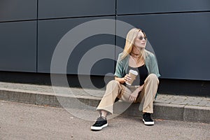 A woman sitting on the curb