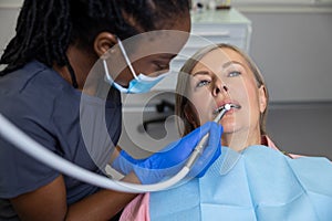 Woman sitting in dental chair teeth treatment