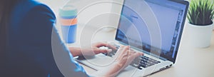 Woman sitting on the desk with laptop