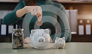 Woman sitting at desk managing expenses, calculating expenses, paying bills using laptop online, making household financial