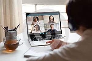 Woman studying at home with multiracial students via video conference photo