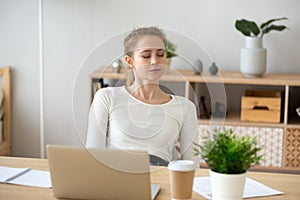 Woman sitting at the desk at office and sleeping