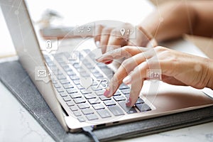 Woman sitting at desk and working at computer close up in hands