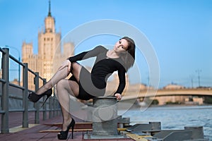 Woman is sitting on device for the mooring of vessel