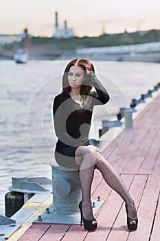 Woman is sitting on device for mooring of vessel