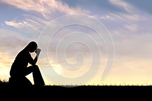 Woman Sitting Down in Prayer Silhouette