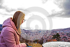 Woman sitting and drinking coffe above Sarajevo