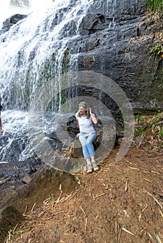 Woman sitting on the edge of the Pancada Grande waterfall. Environment photo