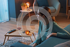 Woman sitting on the floor and drinking wine