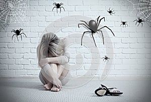 Woman sitting on the floor and looking on imaginary spider.