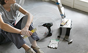 Woman sitting on the floor and planning a home renovation