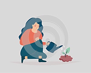 Woman sitting on the floor, watering a small tree. Gardener girl grows plant. Concept of forestation, international earth day