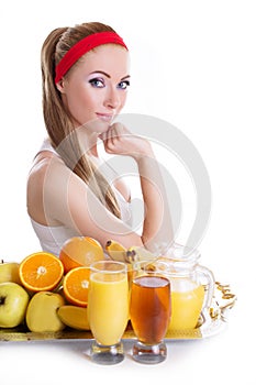 Woman sitting with fresh juices and fruits