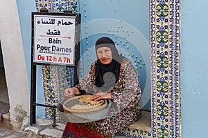 Woman sitting in front of a hammam at Sousse in Tunisia