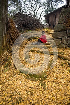 Woman Sitting With Golden Leaves