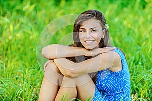 Woman sitting on grass and smiling