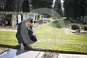 Woman sitting at grave