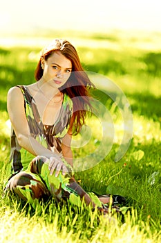 Woman sitting in a green field