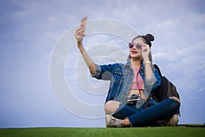 Woman sitting on green grass smiling on the day and photograph s