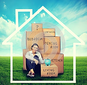 Woman sitting on the green meadow with boxes