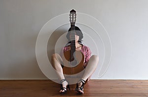 Woman sitting with a guitar photo