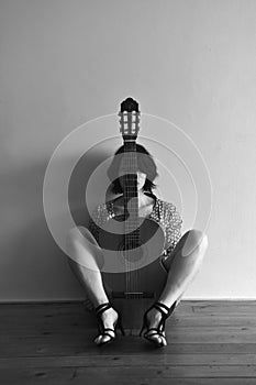woman sitting with a guitar