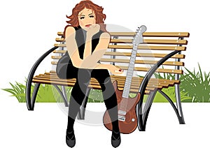 Woman sitting with guitar on the wooden bench