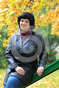 Woman sitting on handrail