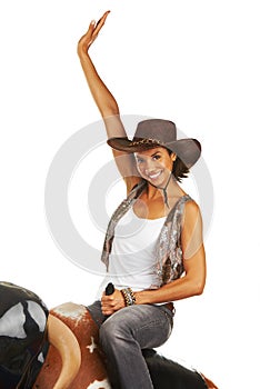 Woman, sitting and hands up on rodeo bull machine for cowboy, western fashion portrait and studio mockup. Workout