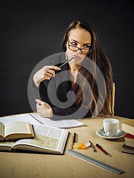 Woman sitting at her desk thinking