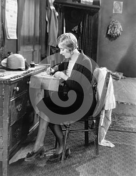 Woman sitting at her desk writing a letter