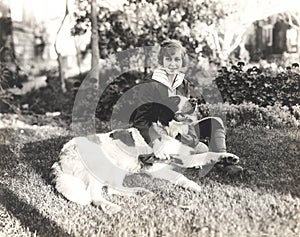 Woman sitting with her dog on grass