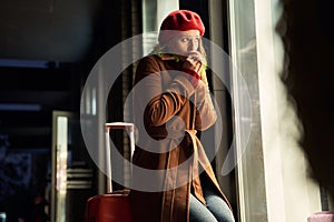 Woman sitting at her luggage