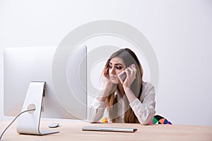 Woman sitting at her workplace with smartphone