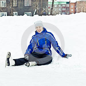 Woman sitting on ice skates.