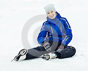 Woman sitting on ice skates.