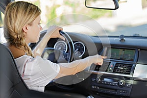 Woman sitting inside car using gps navigation