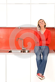 Woman sitting on kitchen counter