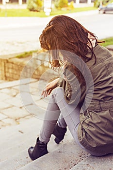 Woman sitting lonely