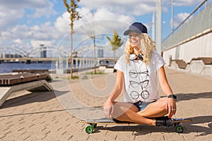 Woman sitting on longboard in lotuss position