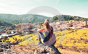 Woman sitting looking at panoramic view of Soria city landscape