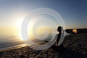 Woman sitting in lotus pose and meditating