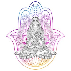 Woman sitting in lotus position on color hamsa hand background.