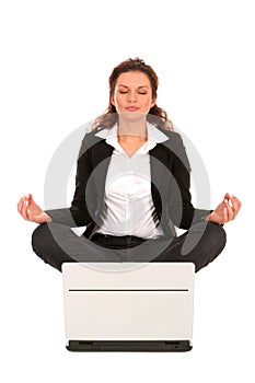 Woman sitting in lotus position with laptop