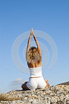 Woman sitting in lotus position photo