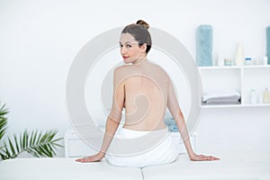 Woman sitting on massage table