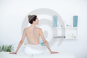 Woman sitting on massage table